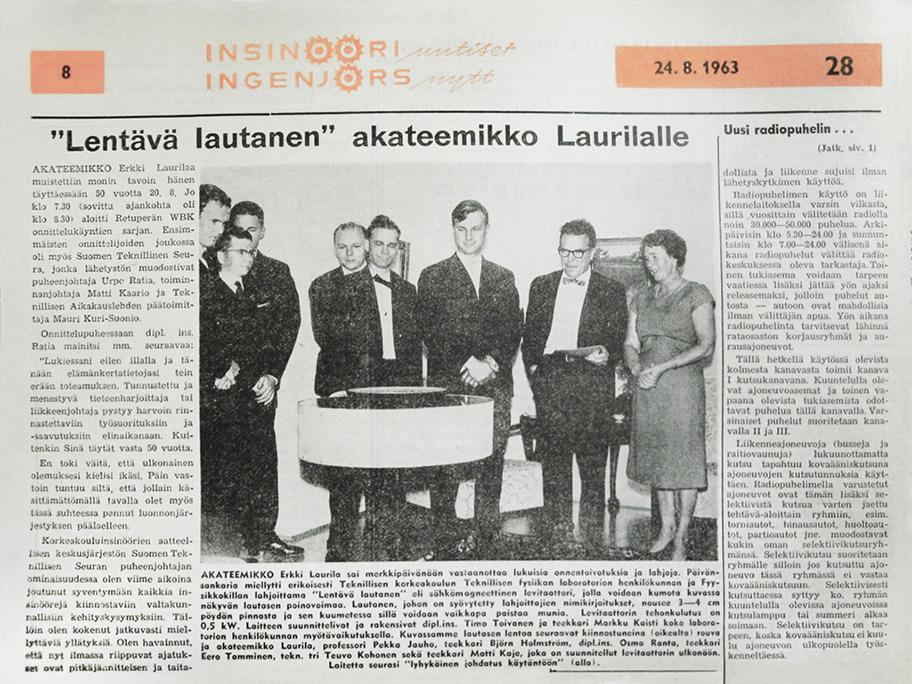 Valokuva vuoden 1963 elokuun Insinööriuutiset-lehden sivusta. Sivun otsikkona on "Lentävä lautanen akateemikko Laurilalle". Jutun yhteydessä on mustavalkoinen valokuva juhla-asuisesta seurueesta katsomassa noin metrin levyistä esinettä.